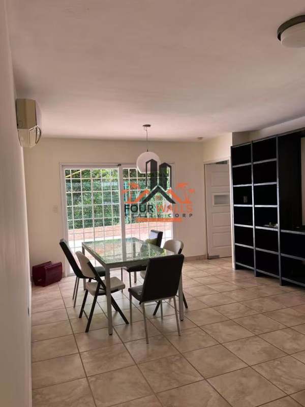 Interior hallway with tiled staircase, framed artwork, desk, and natural lighting in PH Everest Brisas del Golf Panama
