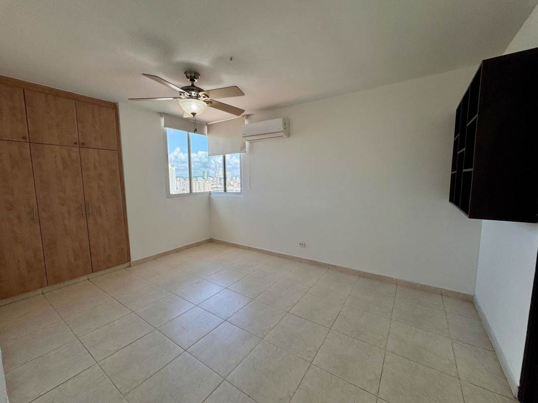 Kitchen with granite countertop, wooden cabinetry and appliances at PH Emporium Tower San Francisco Panama