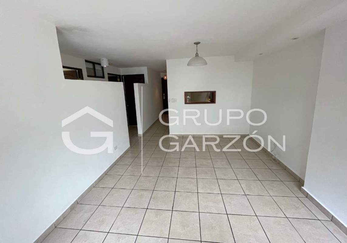 Traditional kitchen with wooden cabinets, granite countertops, appliances in PH Altos de la Colina apartment