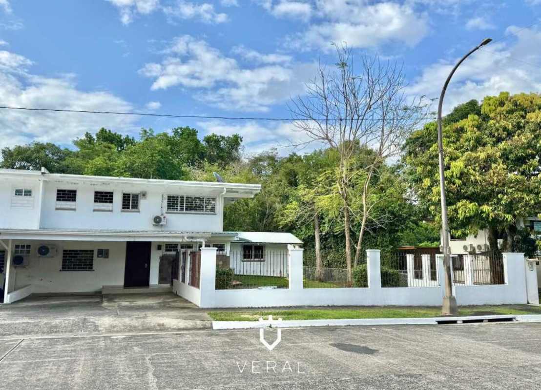 Large enclosed kitchen with granite countertops and wooden cabinets in Cardenas Village Panama