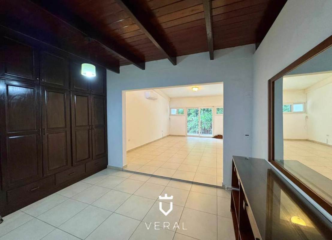 Spacious backyard with mature trees and green lawn in private residential community Panama