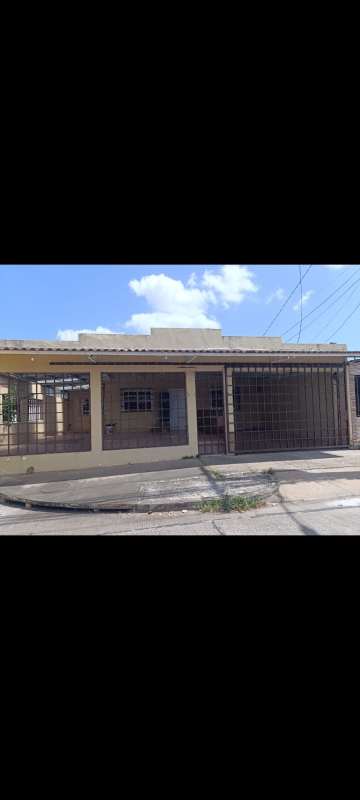 Covered porch with security bars, garage gate in Villas de Don Bosco Panama City
