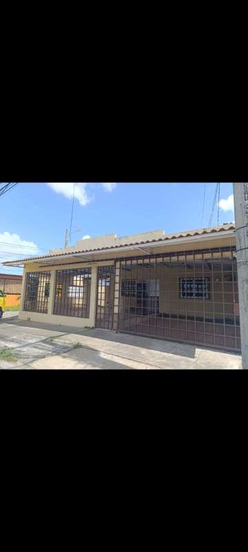 Empty tiled living room with window, beige walls, and drop ceiling in Villas de Don Bosco house Panama City