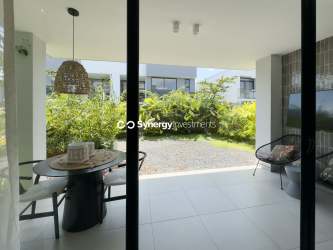 Kitchen with peninsula island, large windows overlooking garden, contemporary appliances