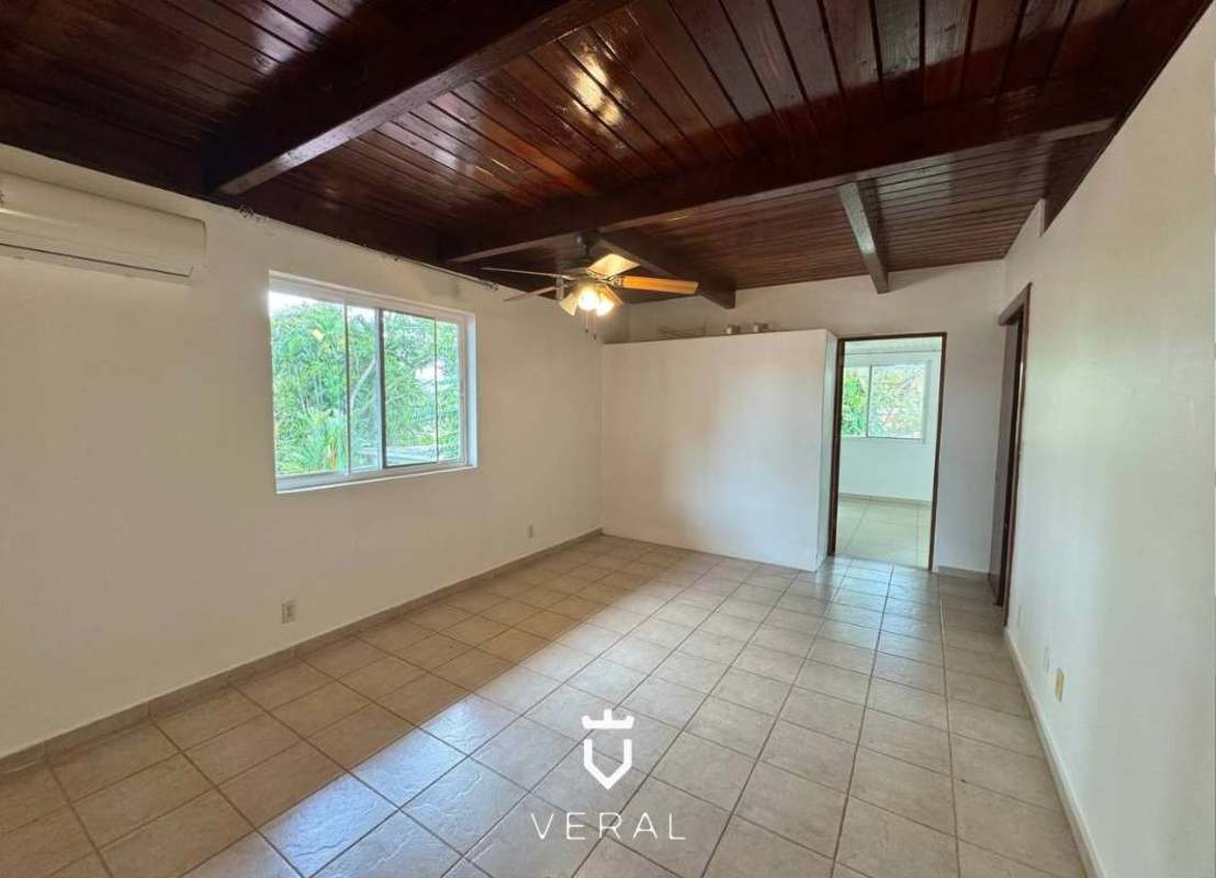 Family room with large window, marble floors overlooking garden in Cardenas Village Panama