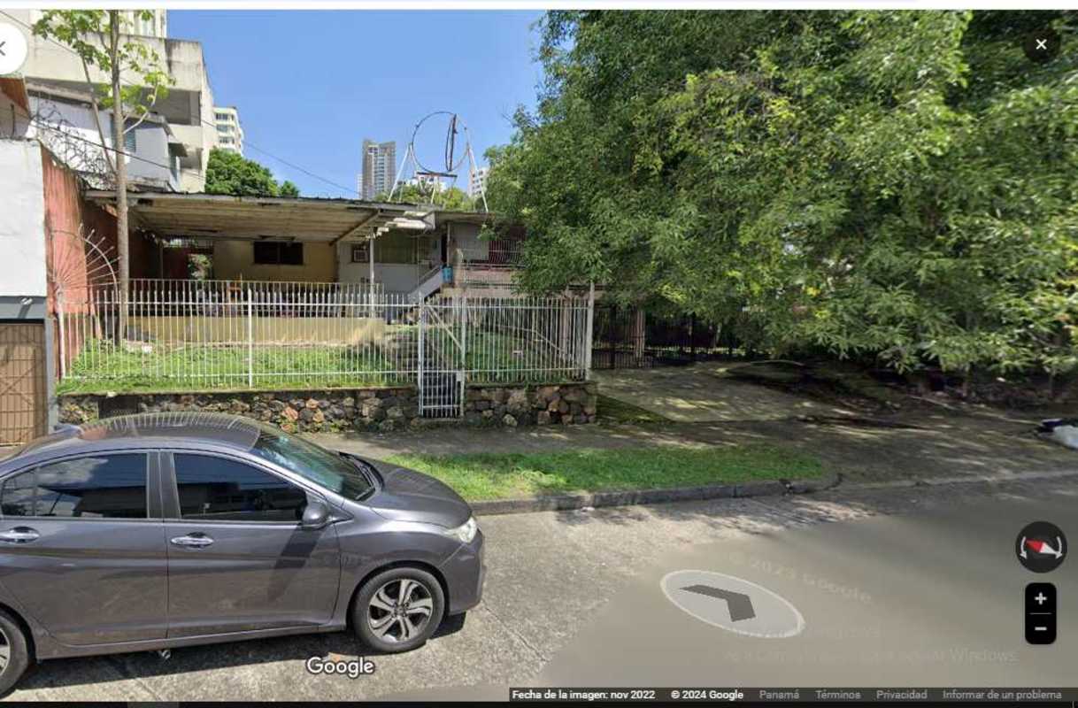 Existing single-story structure shaded by trees on development land El Cangrejo Panama