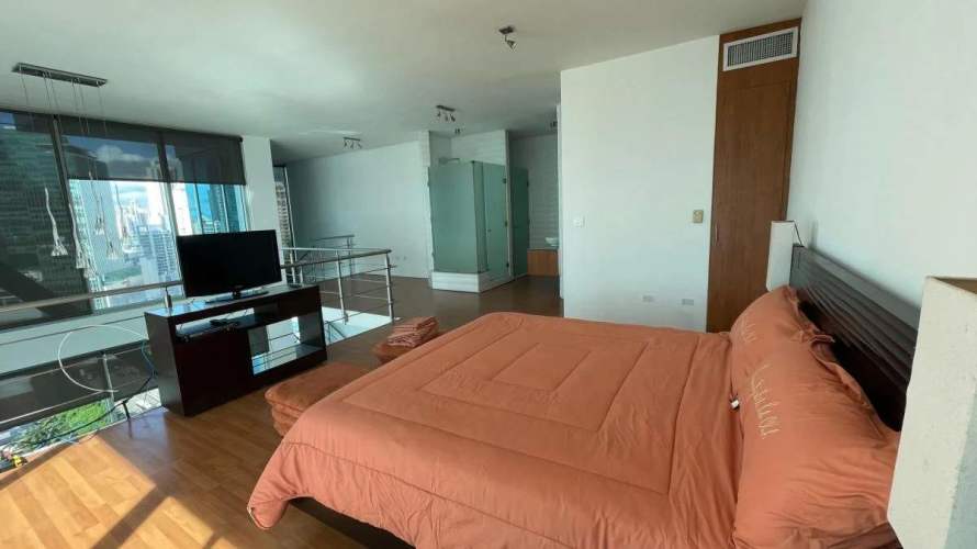 Spacious double-height living room in luxury Punta Pacifica loft condo with skyline and ocean views