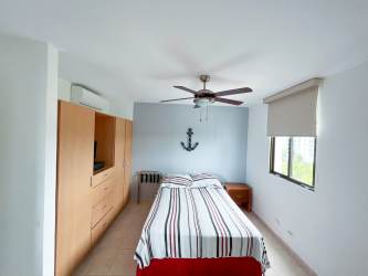 Bright open plan living and dining room fully furnished with coastal decor in resort apartment Playa Blanca Panama