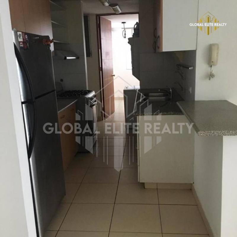 Open kitchen with granite countertops, stove and tile floors PH Pueblo Nuevo Panama City