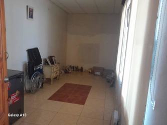 Open interior space with tiled floors, neutral walls, wheelchair, Penonomé Panama