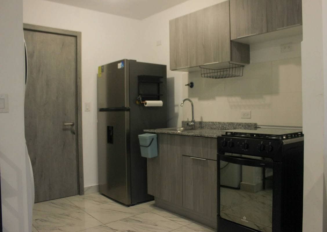 Compact kitchen with fridge stove granite countertop PH Costa Pacifica Panama