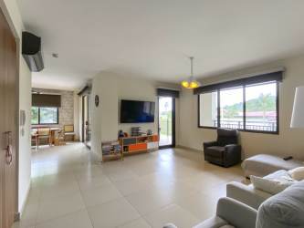 Open-plan living room with large windows tile flooring River Valley Panama Pacifico