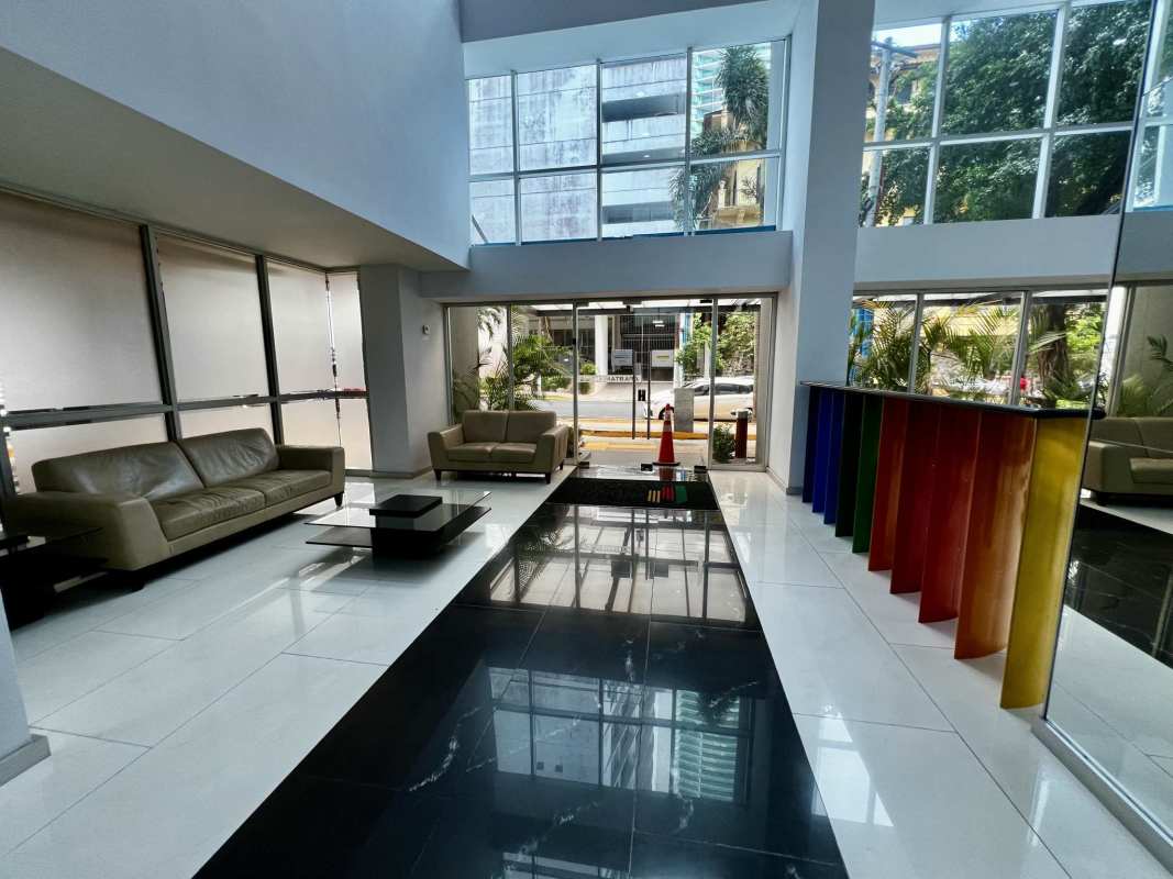 Modern condo lobby with double-height ceilings, reception area in PH Colores de Bella Vista Panama