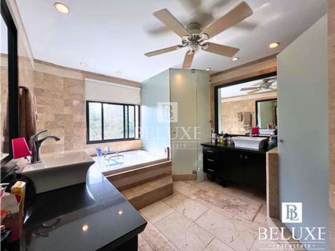 Modern open-plan interior with marble flooring, curved wall and luxury bar setup at PH Elite La Cresta Panama