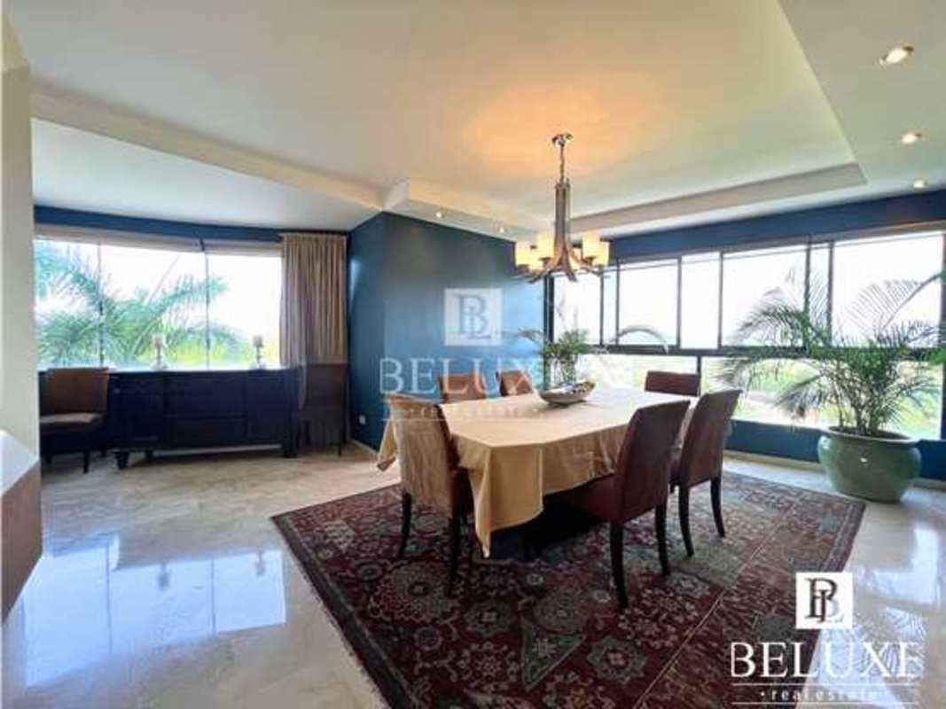 Elegant dining room with marble floors, large windows and modern chandelier in PH Elite La Cresta Panama City