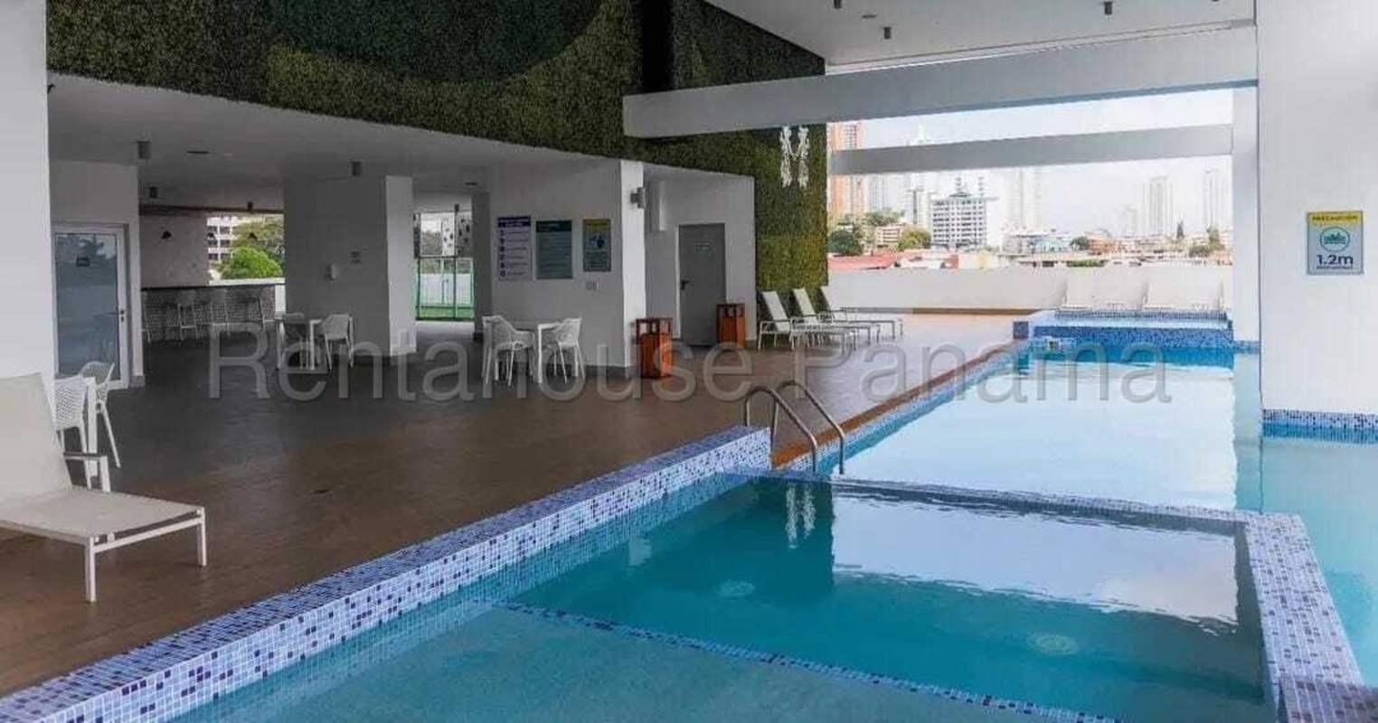 Modern covered pool with lounge seating and city view in PH MIDPARK Carrasquilla