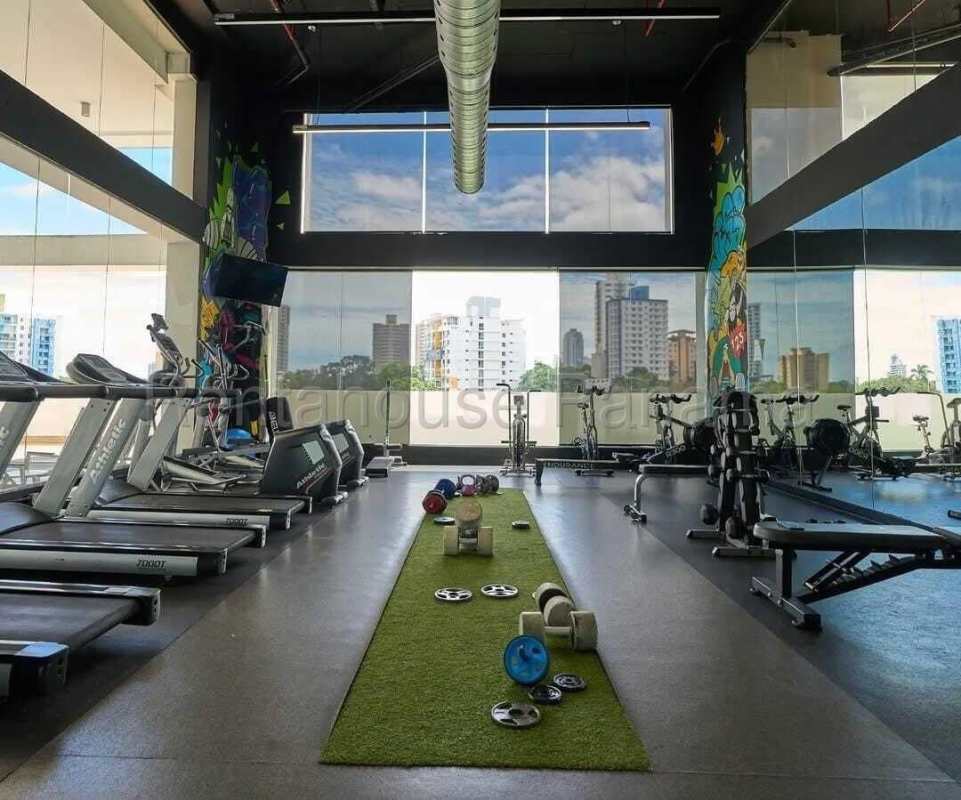 Fully equipped gym with large windows overlooking Panama City skyline in PH MIDPARK