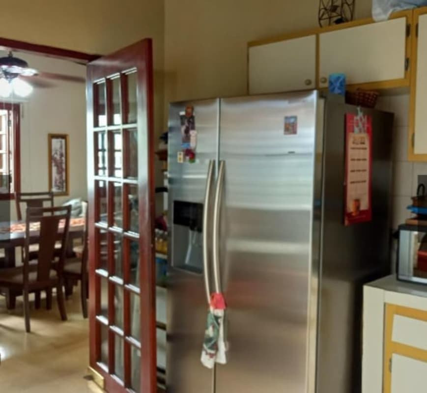 Cozy breakfast nook with floral curtains, round table, traditional decor San Miguelito Panama