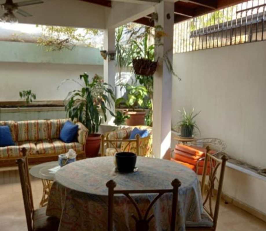 Covered patio terrace with dining and lounge furniture in Panama house San Miguelito