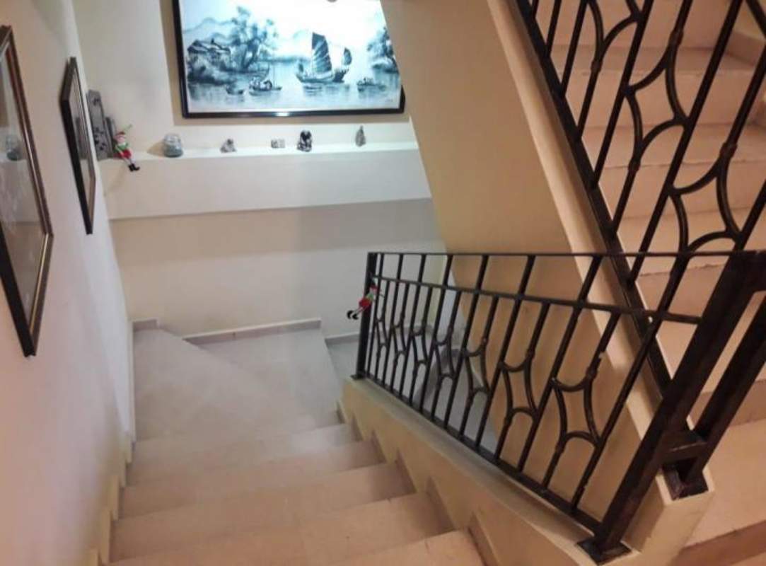 Indoor staircase with tile steps iron railing decorative niche house San Miguelito Panama