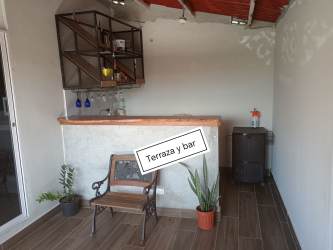 Bright bedroom with tile floors and large windows in Quintas del Pacífico house