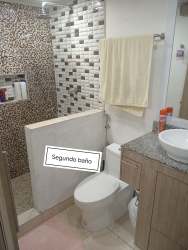 Modern kitchen with granite countertops and appliances in Quintas del Pacífico house