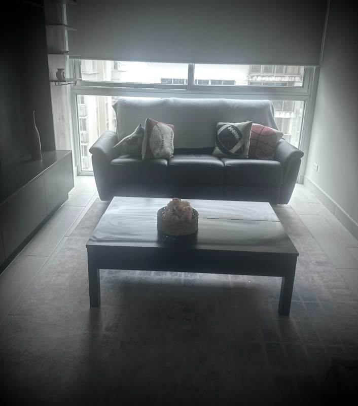 Living room with black leather sofa, blinds, modern decor PH Urbana Obarrio Panama