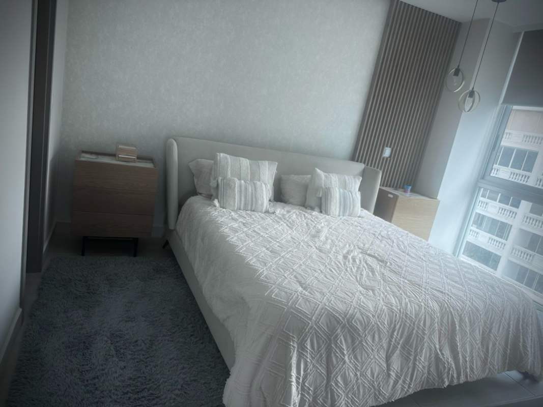 Bedroom with city views, wall-mounted TV, vanity desk PH Urbana Obarrio Panama