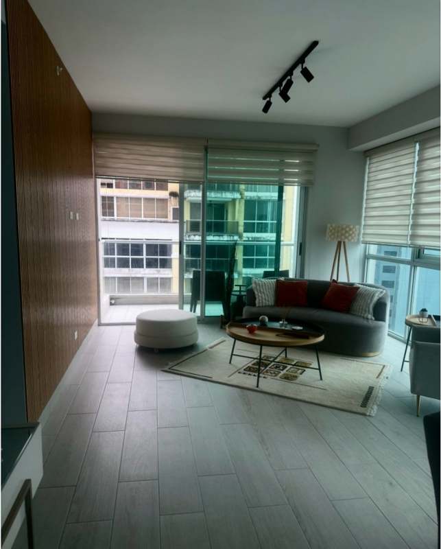 Modern living room with floor-to-ceiling glass doors, balcony view PH Urbana Obarrio Panama City