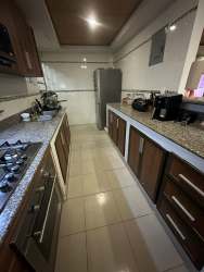 Gated covered parking garage with security features at Praderas del Campo La Chorrera