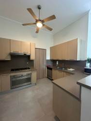 Bedroom with ceiling fan, built-in closets and large windows in Bijao Beach residence Panama