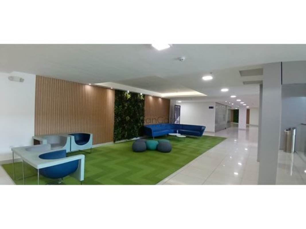 Lobby area with blue sofa, green plants, vertical garden at PH BICSA Tower Panama City