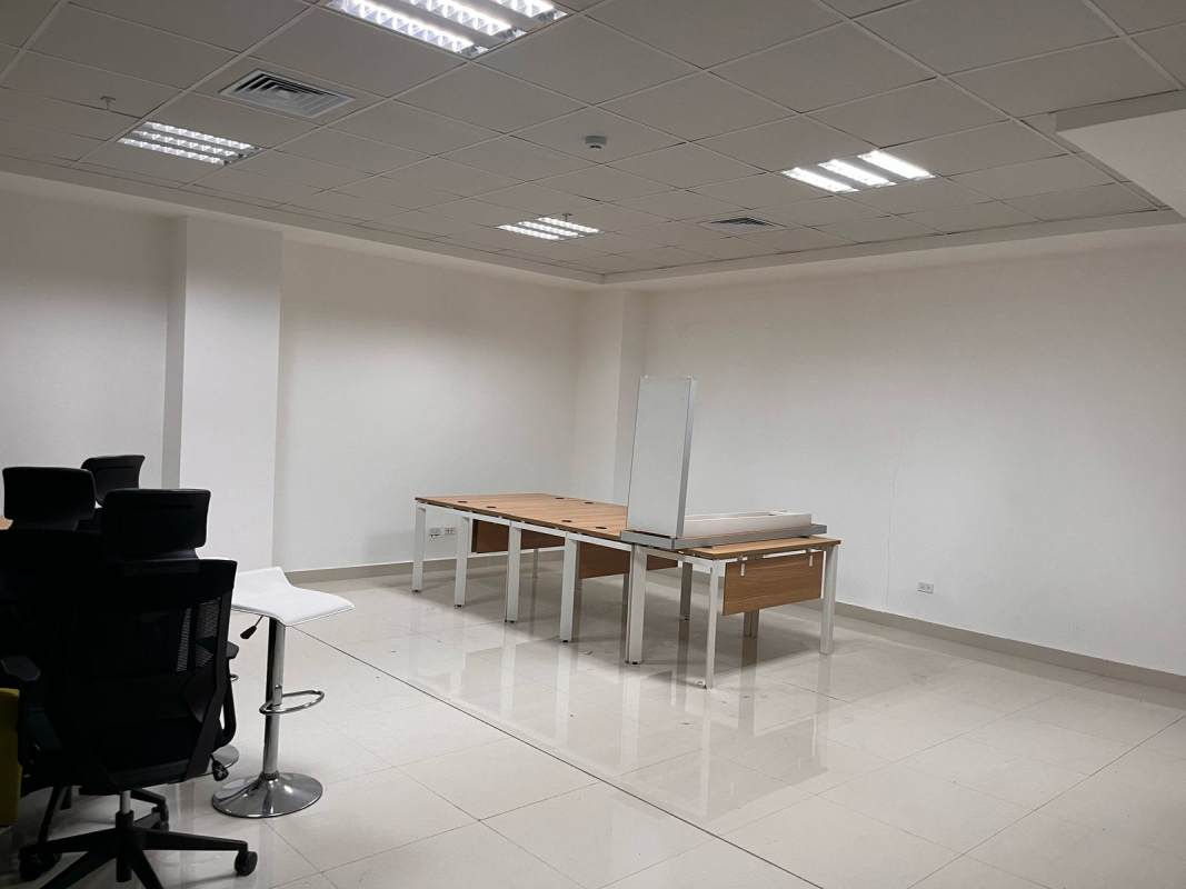 Office workspace area with desks, chairs and tiled floors PH BICSA Tower