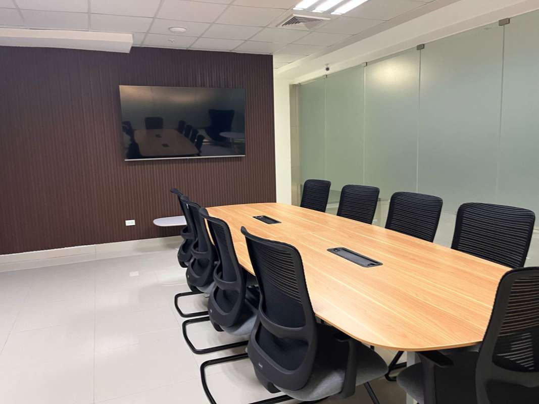 Reception area with navy chairs and glass walls in modern commercial tower Avenida Balboa Panama