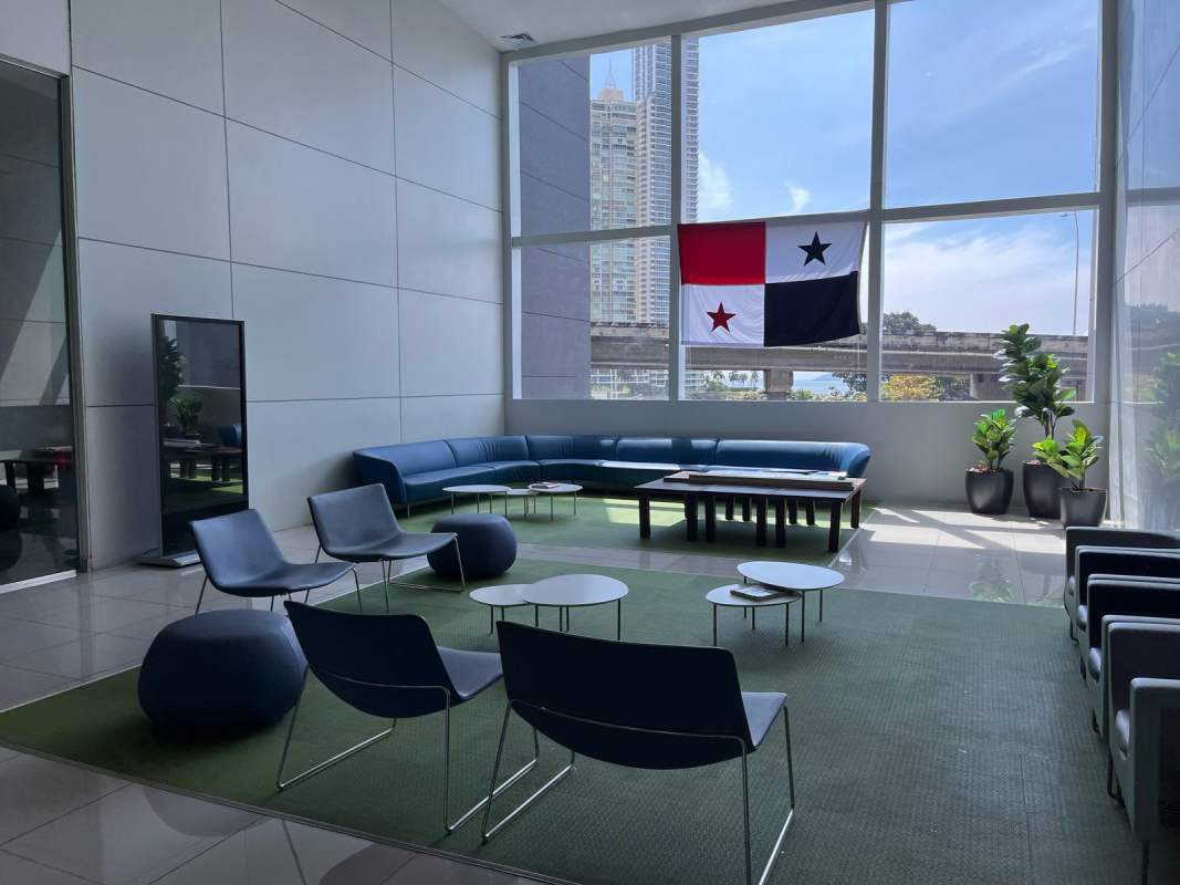 Modern lobby with large windows city skyline view Panamanian flag PH BICSA Financial Center Panama