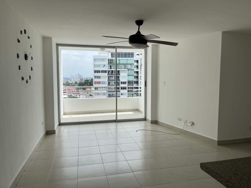 Minimalist empty living room with large window, ceiling fan, and bright tiled floor in Central Park Panama