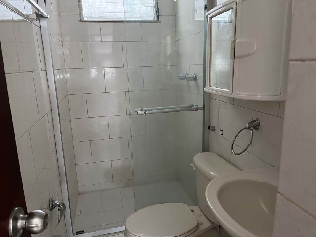 Traditional bathroom with enclosed glass shower, mirror cabinet, and ceramic tiles in PH Central Park