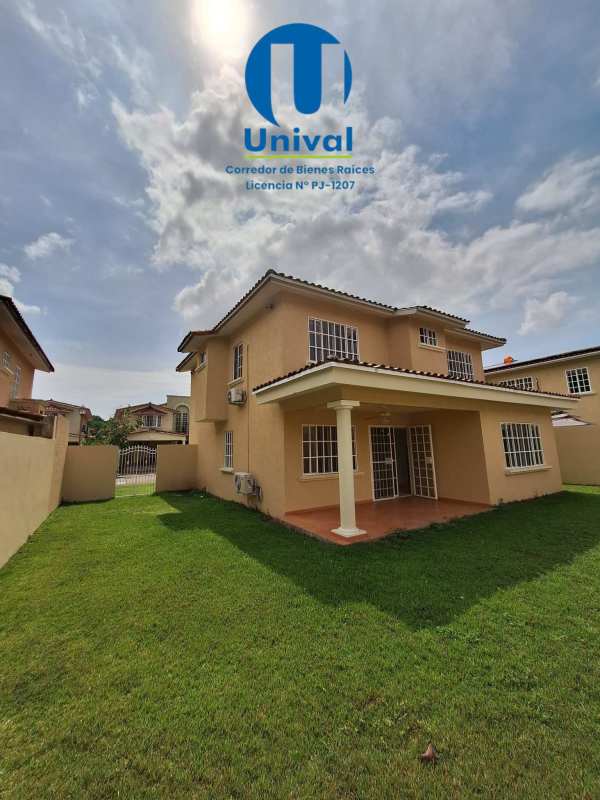 Two-story beige home with fenced yard and covered patio in Albrook Gardens Balboa Panama