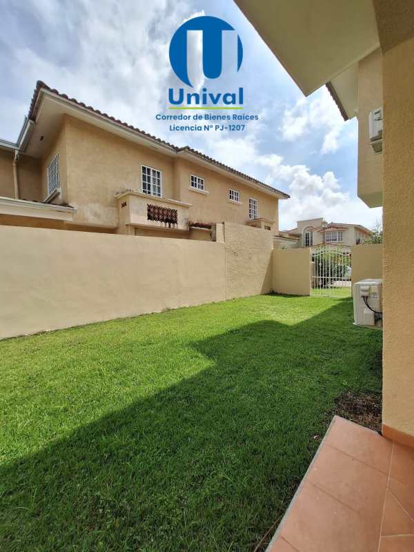 Spacious fenced backyard with green lawn, private patio Albrook Gardens Panama house