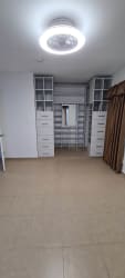 Spacious walk-in closet with built-in shelving drawers and mirror townhouse Residencias Las Lajas Panama