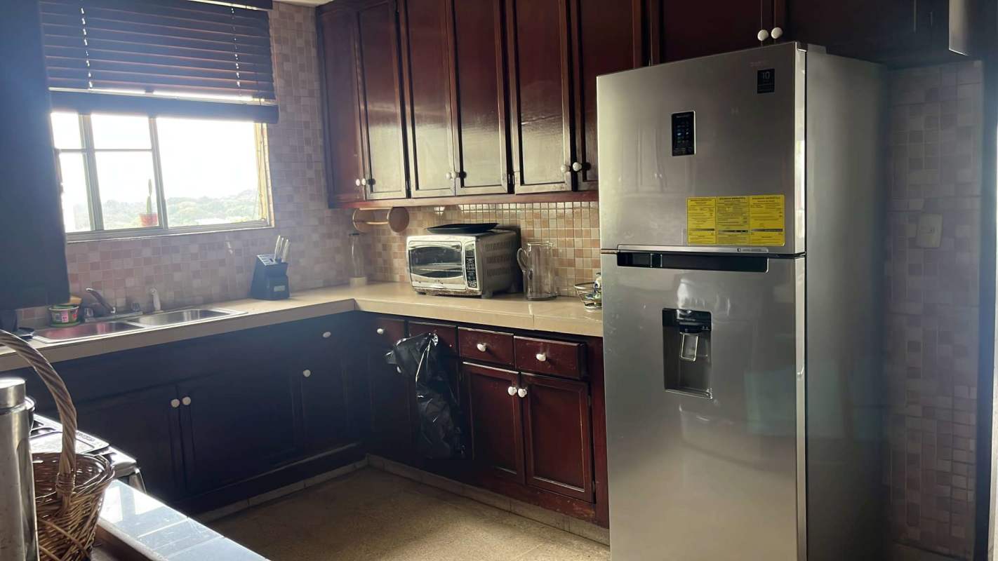 Closed traditional kitchen with granite countertops, wooden cabinets PH Via Argentina Panama