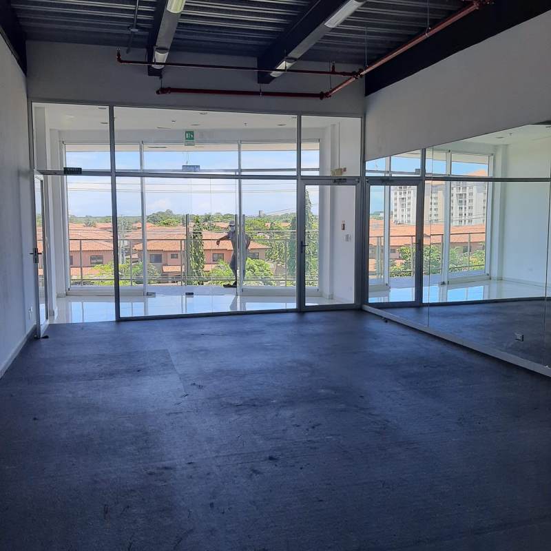 Multi-level commercial plaza with Smart Fit signage parking and storefronts in Don Bosco Panama City