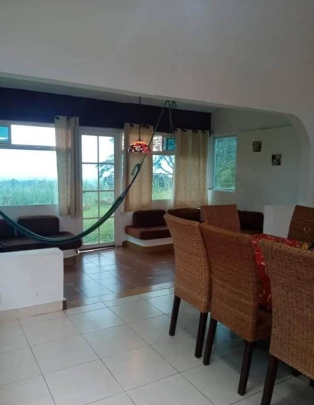 Red cottage-style villa with driveway, carport, gardens in Cerro Azul mountain estates Panama