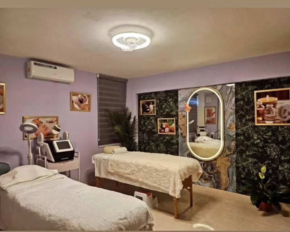 Spa room with two massage tables, wall mirror, artistic decor in Bella Vista commercial plaza Panama
