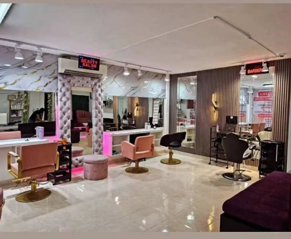 Modern beauty salon with workstations, marble walls, retail clothing area in Vista Hermosa Panama City