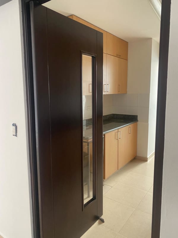 Contemporary kitchen with light wood cabinets and granite countertops at PH Riverside Costa del Este Panama