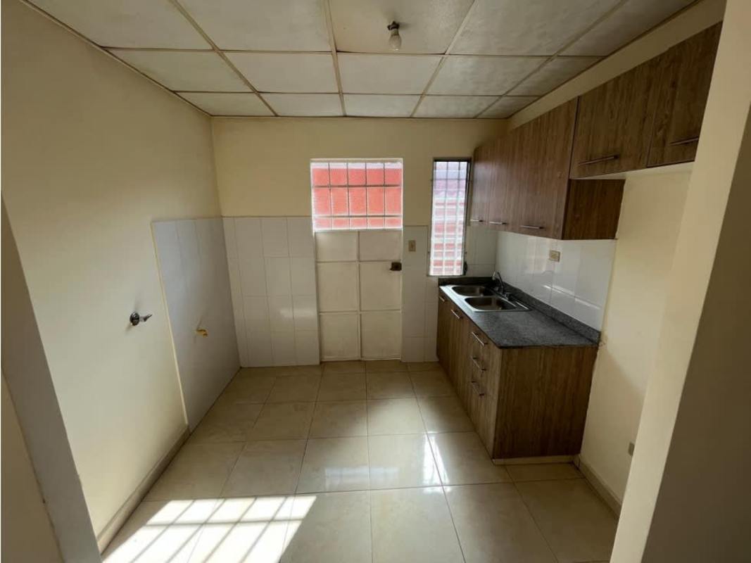 Small modern kitchen granite countertop wooden cabinets tile floor in house PH Colinas del Lago Panama
