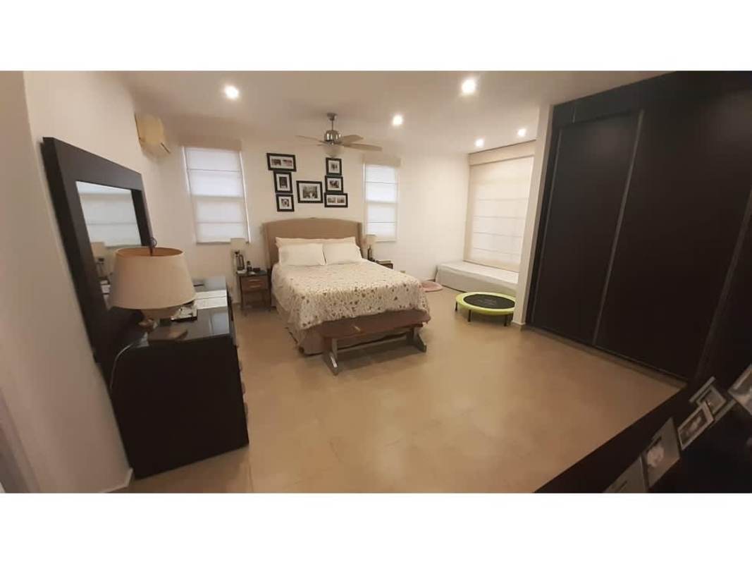 Dining area in Panama house with glass dining table, six chairs and large windows Villa Valencia