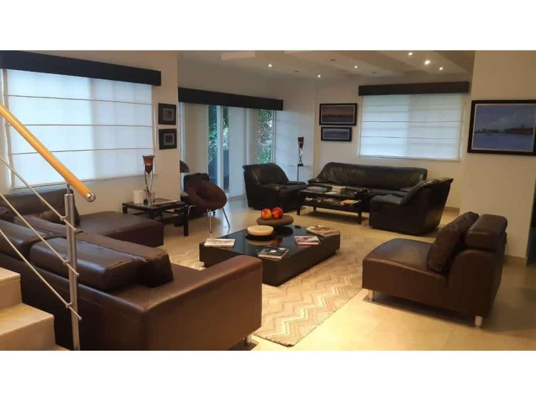 Bedroom with workspace setup, wall art and large windows Costa Sur Panama house