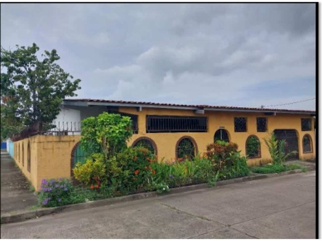 Corner house yellow stucco and red tile landscaped fenced garden Urbanización Anayansi Panama